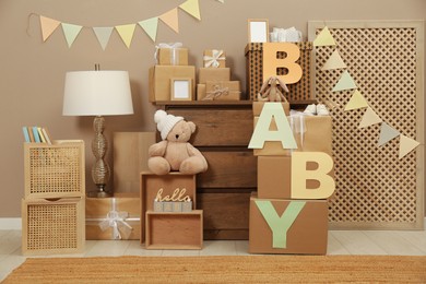 Gift boxes and toys in room decorated for baby shower party