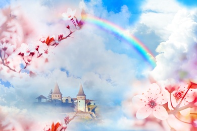 Fantasy world. Beautiful rainbow in sky with fluffy clouds over enchanted castle