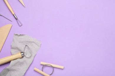 Photo of Set of clay modeling tools on violet background, flat lay. Space for text