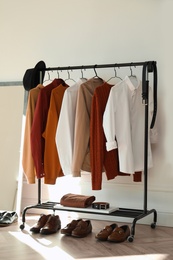 Photo of Rack with stylish clothes indoors. Interior design