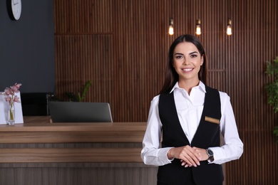 Portrait of receptionist at desk in lobby