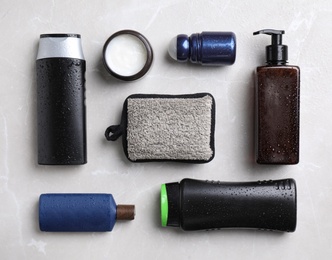 Flat lay composition with men's cosmetics on light grey marble background