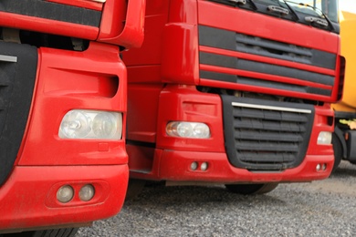 Modern red trucks parked on road, closeup