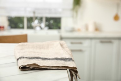 Clean towel on white marble table in kitchen. Space for text