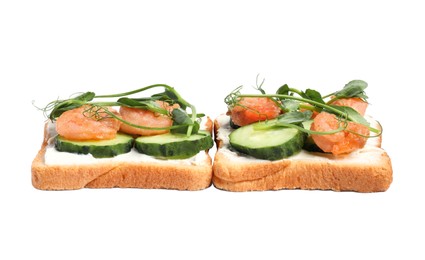 Tasty toasts with cream cheese, shrimps, cucumbers and microgreens on white background