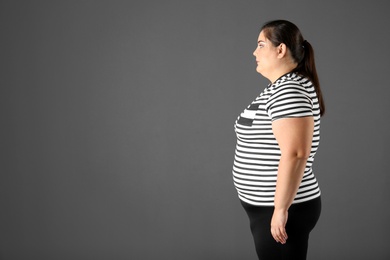 Photo of Portrait of overweight woman and space for text on gray background