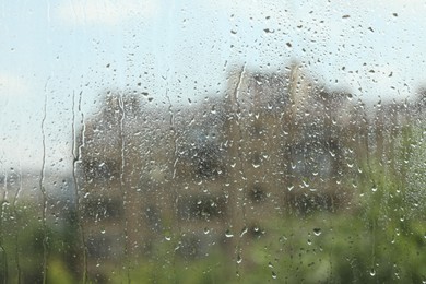Photo of Window glass with raindrops as background, closeup