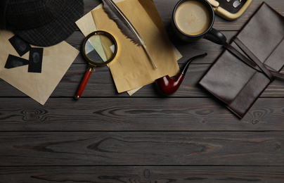 Flat lay composition with vintage detective items on grey wooden background, space for text