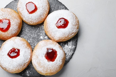 Hanukkah food doughnuts with jelly and sugar powder served on grey table, top view