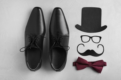 Flat lay composition with shoes, bow tie and paper decor on gray background. Happy Father's Day