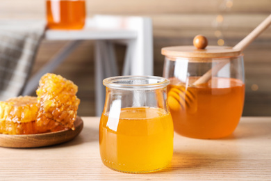 Tasty fresh organic honey on wooden table