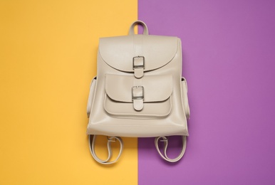 Stylish urban backpack on color background, top view