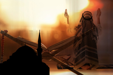 Image of Multiple exposure of Muslim man praying, silhouette of mosque and stand with Koran