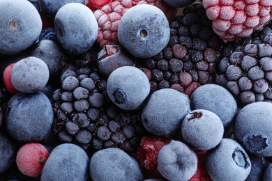 Mix of different frozen berries as background, top view