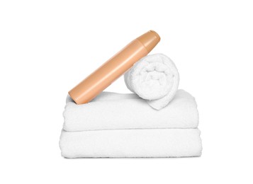 Soft terry towels with cosmetic product on white background