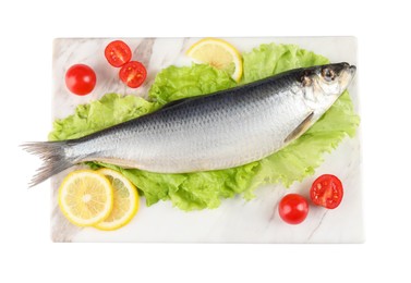Photo of Board with salted herring, slices of lemon, lettuce and cherry tomatoes isolated on white, top view