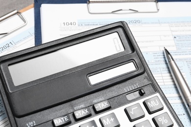 Calculator, documents and pen on table, closeup. Tax accounting