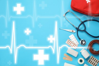 First aid kit and illustration of heartbeat rate with symbols cross on light blue background, flat lay