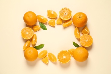 Flat lay composition with ripe oranges and space for text on color background