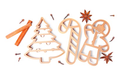 Photo of Different cookie cutters and spices on white background, top view