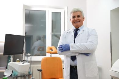 Photo of Portrait of professional surgeon in modern clinic. Space for text