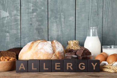 Different products on wooden background. Food allergy concept