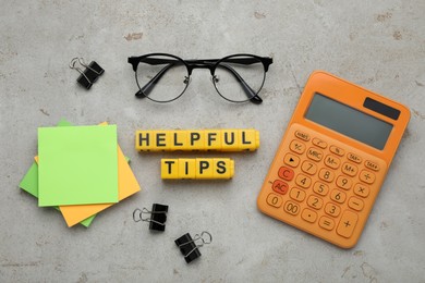Photo of Flat lay composition with text Helpful Tips of yellow cubes on grey table