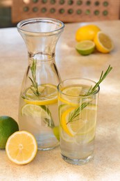Photo of Summer refreshing lemonade on light table in cafe