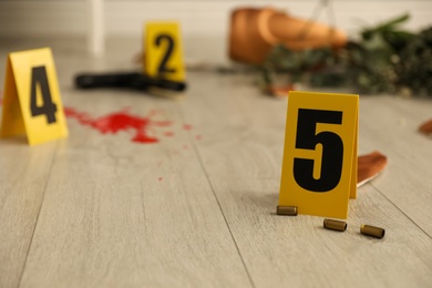 Crime scene markers and casings on floor indoors