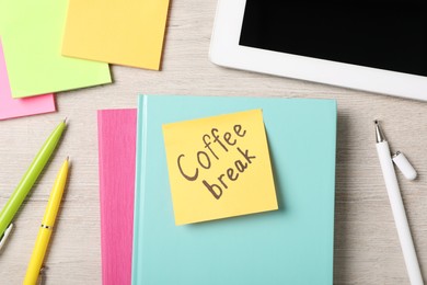 Sticky note with phrase Coffee Break, stationery and tablet on light wooden table, flat lay