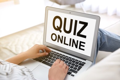 Woman using modern laptop for taking quiz online at home, closeup