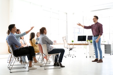 Male business trainer giving lecture in office