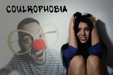 Image of Coulrophobia concept. Scared woman and phantom of clown