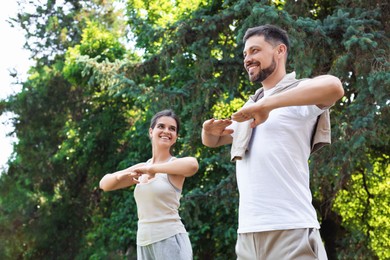 Man and woman doing morning exercise in park