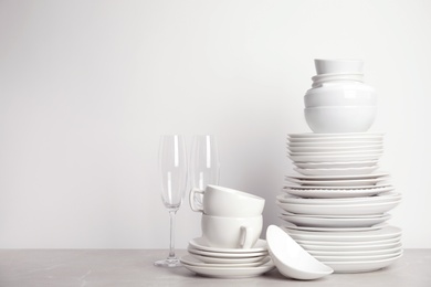 Set of clean tableware on white table