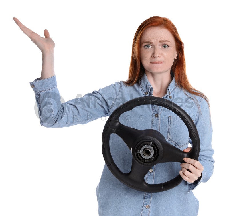 Emotional young woman with steering wheel on white background