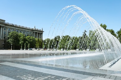 City square with beautiful fountains on sunny day