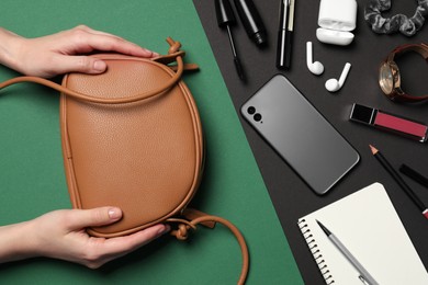 Woman with stylish bag, smartphone and different accessories on color background, top view