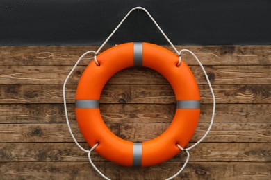 Orange lifebuoy hanging on wall. Rescue equipment