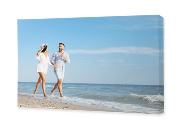 Photo printed on canvas, white background. Happy young couple running together on beach