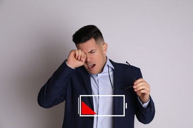 Image of Tired man yawning and illustration of discharged battery on light grey background