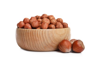 Bowl with tasty organic hazelnuts on white background
