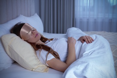 Young woman with mask sleeping in bed. Tip for manage sleep deprivation