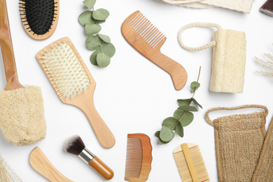 Frame of hair combs and brushes on white background, top view. Space for text