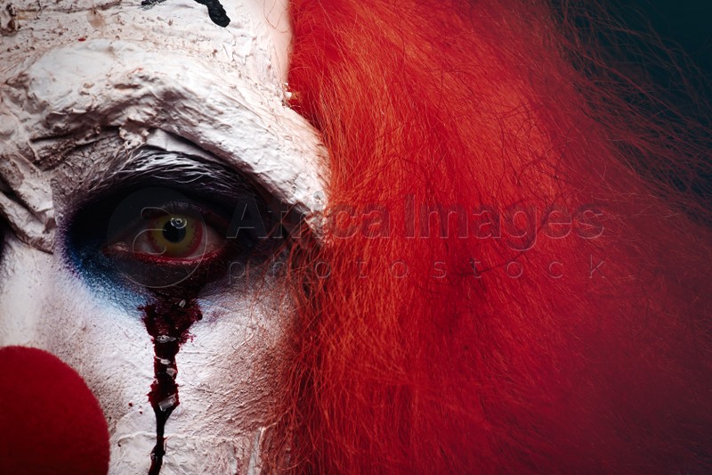Photo of Terrifying clown, closeup view. Halloween party costume