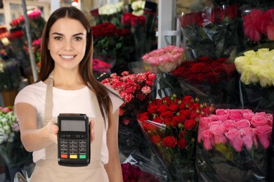 Woman with terminal for contactless payment in flower shop