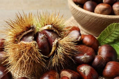 Fresh sweet edible chestnuts on table, closeup
