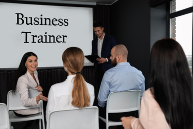 Professional business trainer and his students in conference room with projection screen
