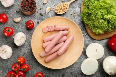 Fresh raw vegetarian sausages, soybeans and vegetables on grey table, flat lay