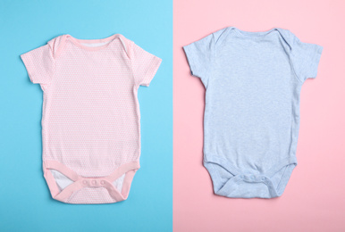 Child's bodysuit on light blue and pink background, flat lay